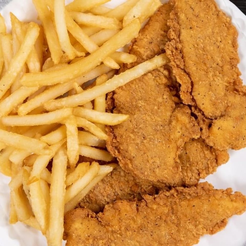 A close-up of golden-brown CFC Fried Chicken tenders and crispy french fries.